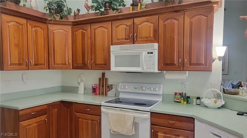 126-128 Tangerine Road Lake Placid, FL 33852 - Photo 7 of 29 a kitchen with stainless steel appliances granite countertop a refrigerator and sink