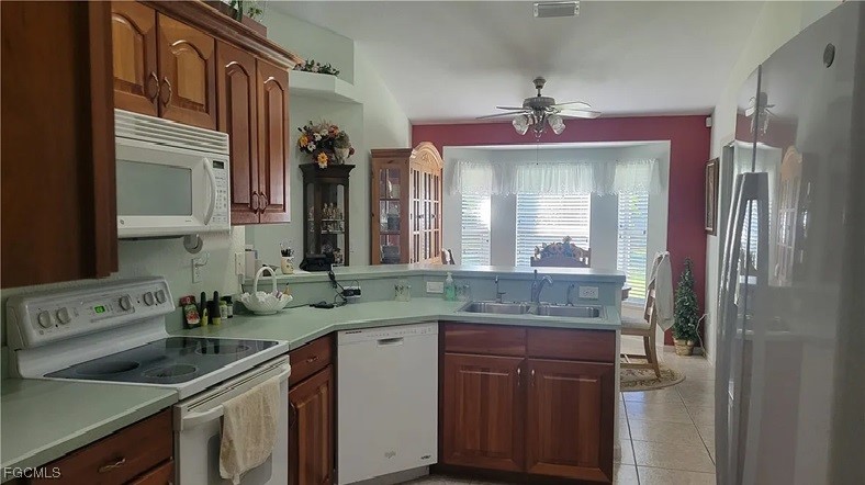 126-128 Tangerine Road Lake Placid, FL 33852 - Photo 8 of 29 a kitchen with a sink stove and cabinets
