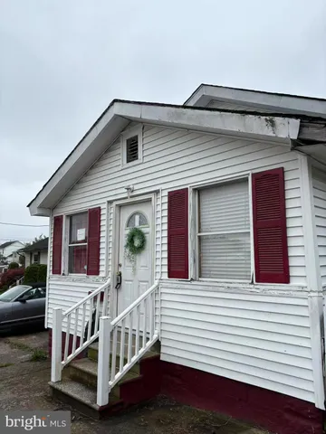 a view of house with a deck and furniture