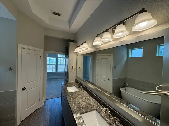 a bathroom with a bathtub and shower