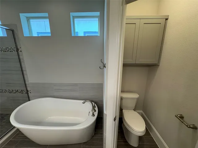 a bathroom with a toilet sink and shower