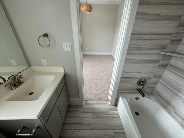a bathroom with a glass door shower and toilet