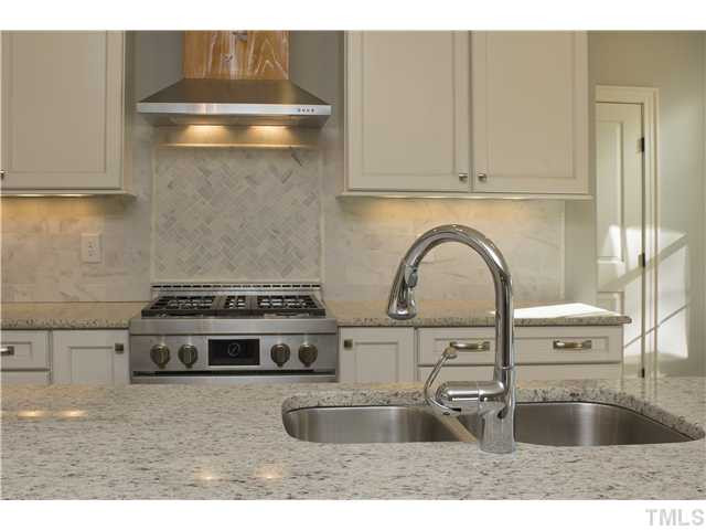 8505 Wynhurst Court, Unit 15 Raleigh, NC 27613 - Photo 11 of 25 a kitchen with stainless steel appliances granite countertop a sink stove and cabinets