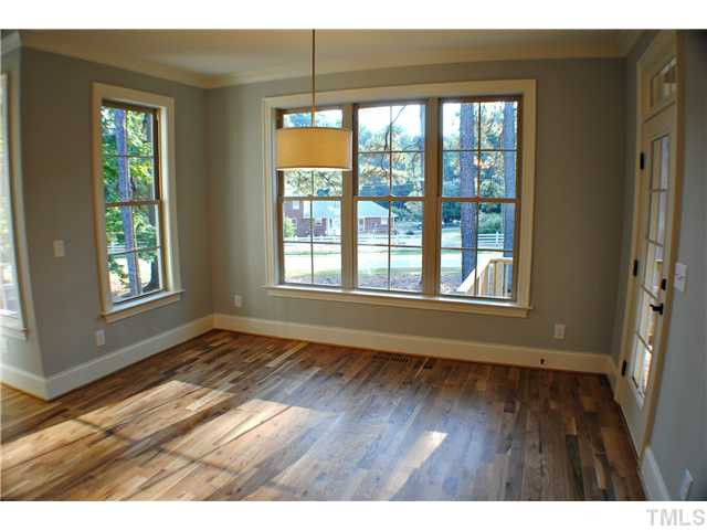 8505 Wynhurst Court, Unit 15 Raleigh, NC 27613 - Photo 13 of 25 a view of an empty room with wooden floor and a window