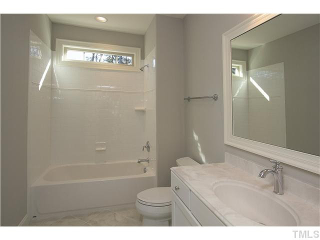 8505 Wynhurst Court, Unit 15 Raleigh, NC 27613 - Photo 18 of 25 a bathroom with a sink a toilet and shower