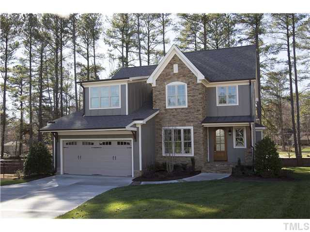 8505 Wynhurst Court, Unit 15 Raleigh, NC 27613 - Photo 2 of 25 a front view of a house with a yard and garage