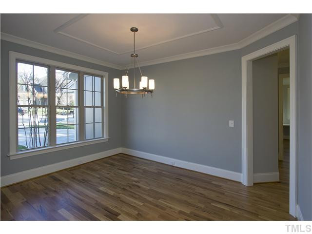 8505 Wynhurst Court, Unit 15 Raleigh, NC 27613 - Photo 5 of 25 a view of an empty room with wooden floor and a window