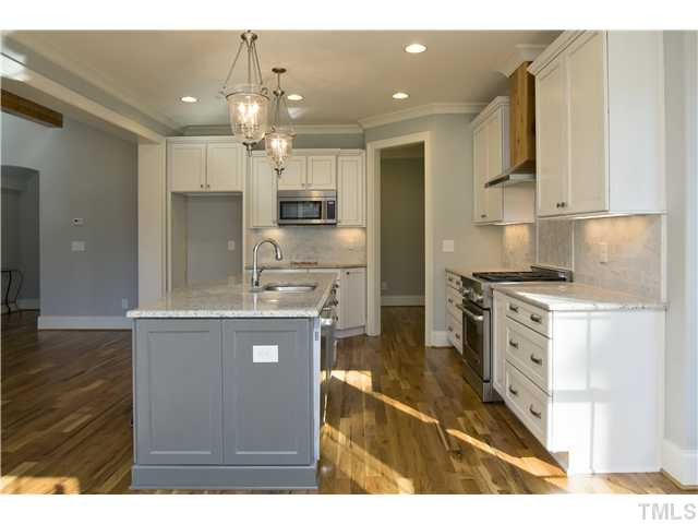 8505 Wynhurst Court, Unit 15 Raleigh, NC 27613 - Photo 10 of 25 a kitchen with kitchen island a counter top space a sink stainless steel appliances and cabinets