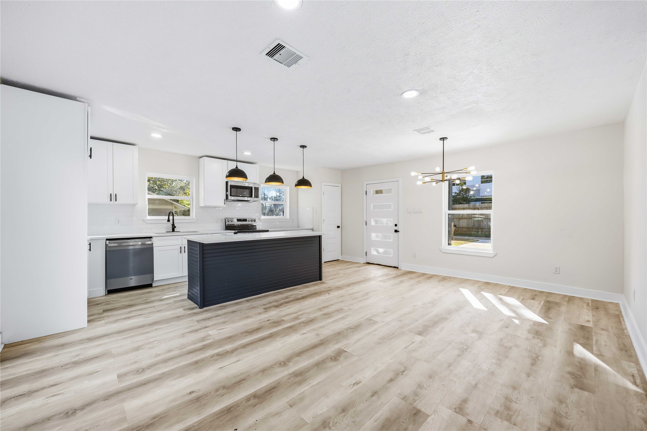 18234 Atkinson Lane Conroe, TX 77384 - Photo 6 of 30 a view of kitchen with sink microwave and refrigerator