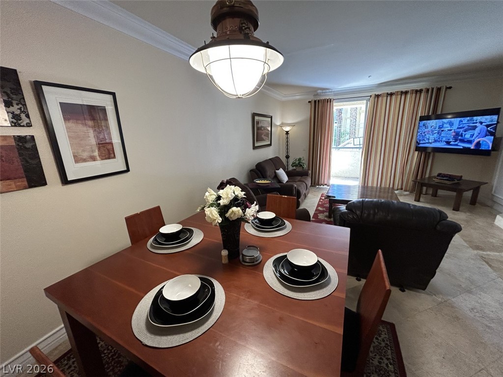 210 East Flamingo Road, Unit 137 Las Vegas, NV 89169 - Photo 9 of 32 An inviting dining area flows seamlessly into a well-lit living space, creating an open ambiance.