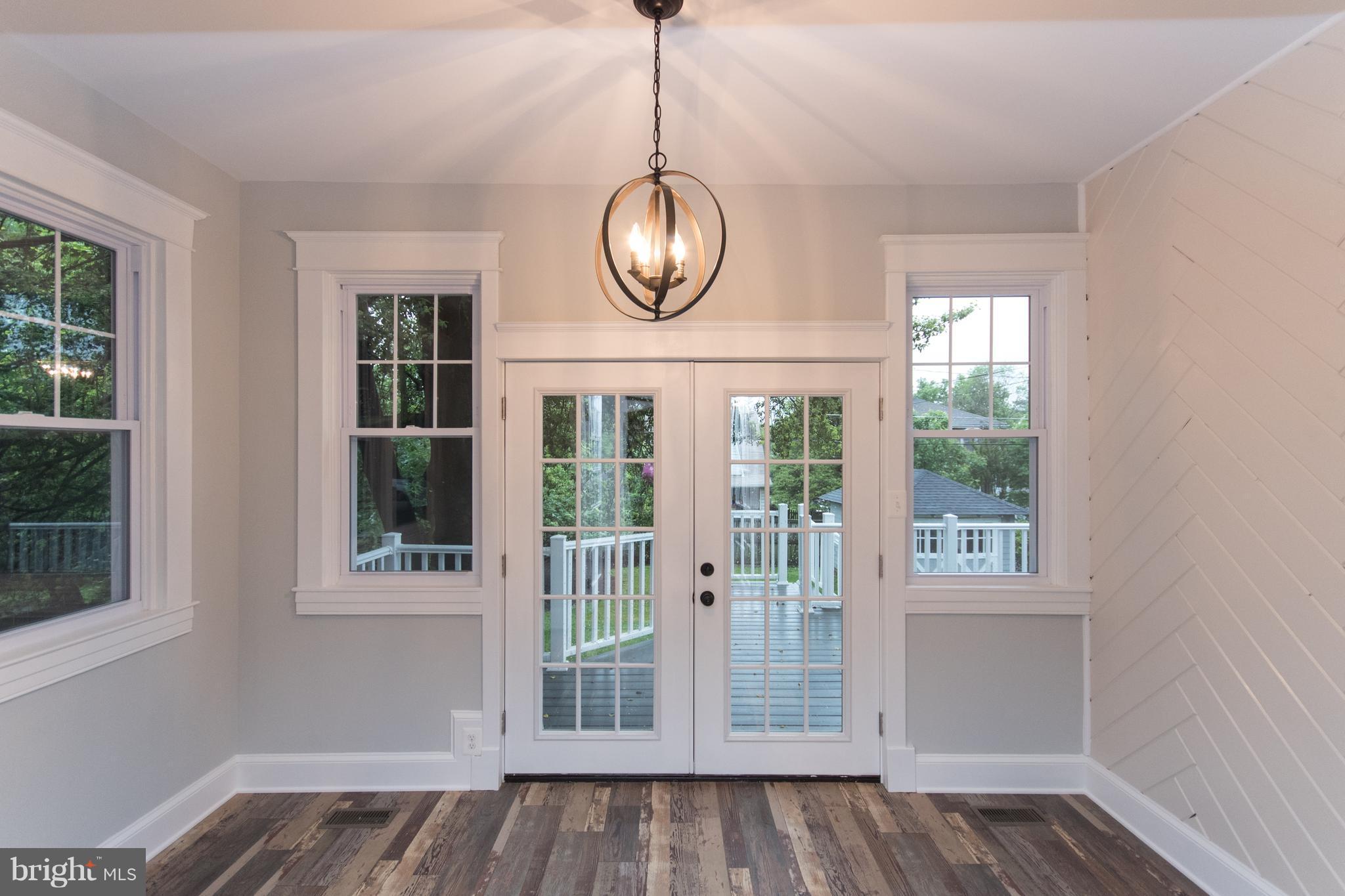 511 Dunkirk Road Baltimore, MD 21212 - Photo 13 of 27 a view of an empty room with wooden floor and a window
