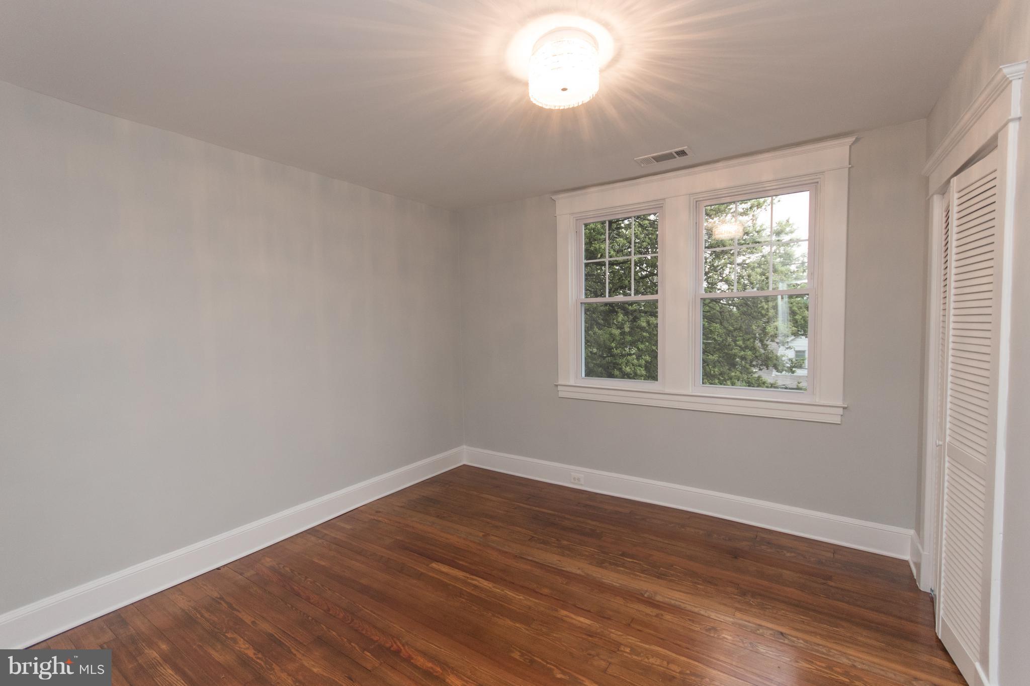 511 Dunkirk Road Baltimore, MD 21212 - Photo 16 of 27 a view of a room with wooden floor and windows in it