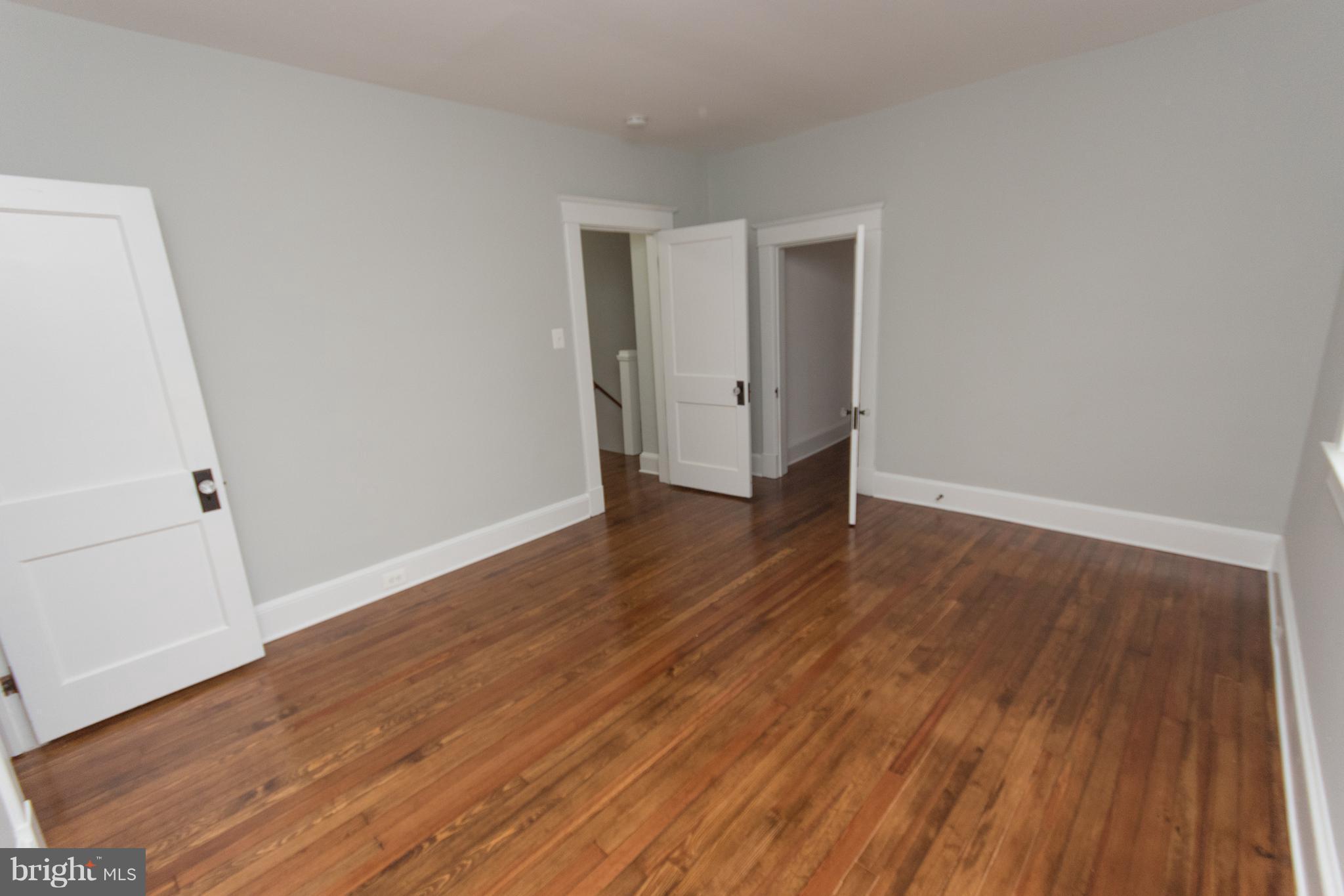 511 Dunkirk Road Baltimore, MD 21212 - Photo 18 of 27 a view of a room with wooden floor and white doors