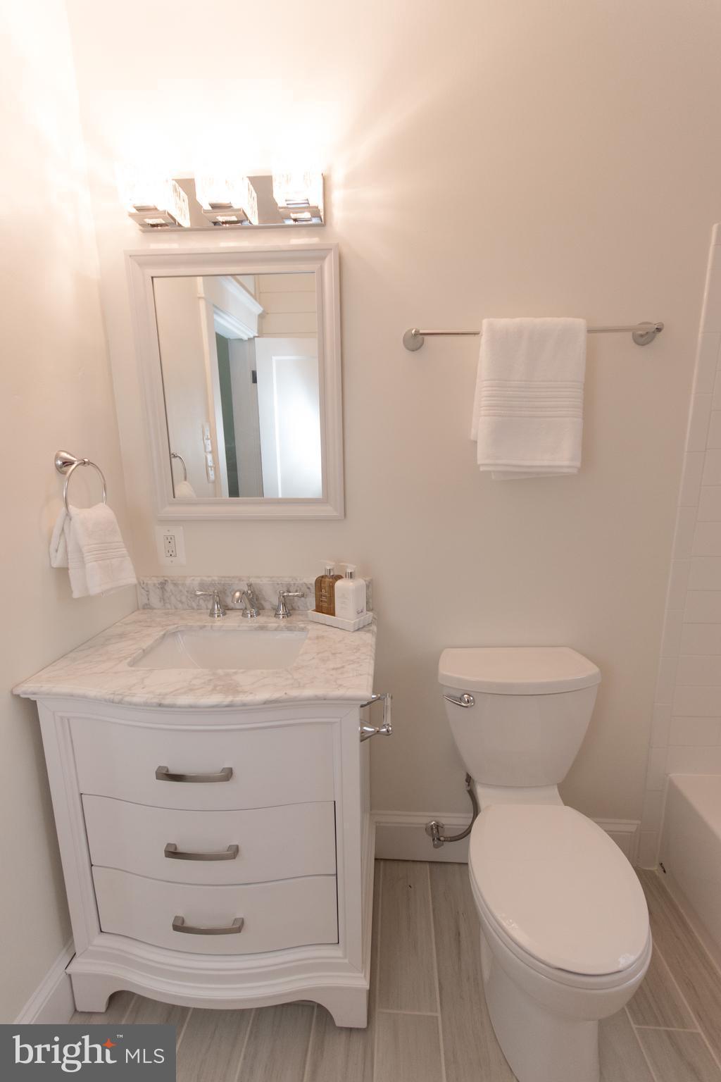 511 Dunkirk Road Baltimore, MD 21212 - Photo 19 of 27 a bathroom with a toilet a sink and mirror