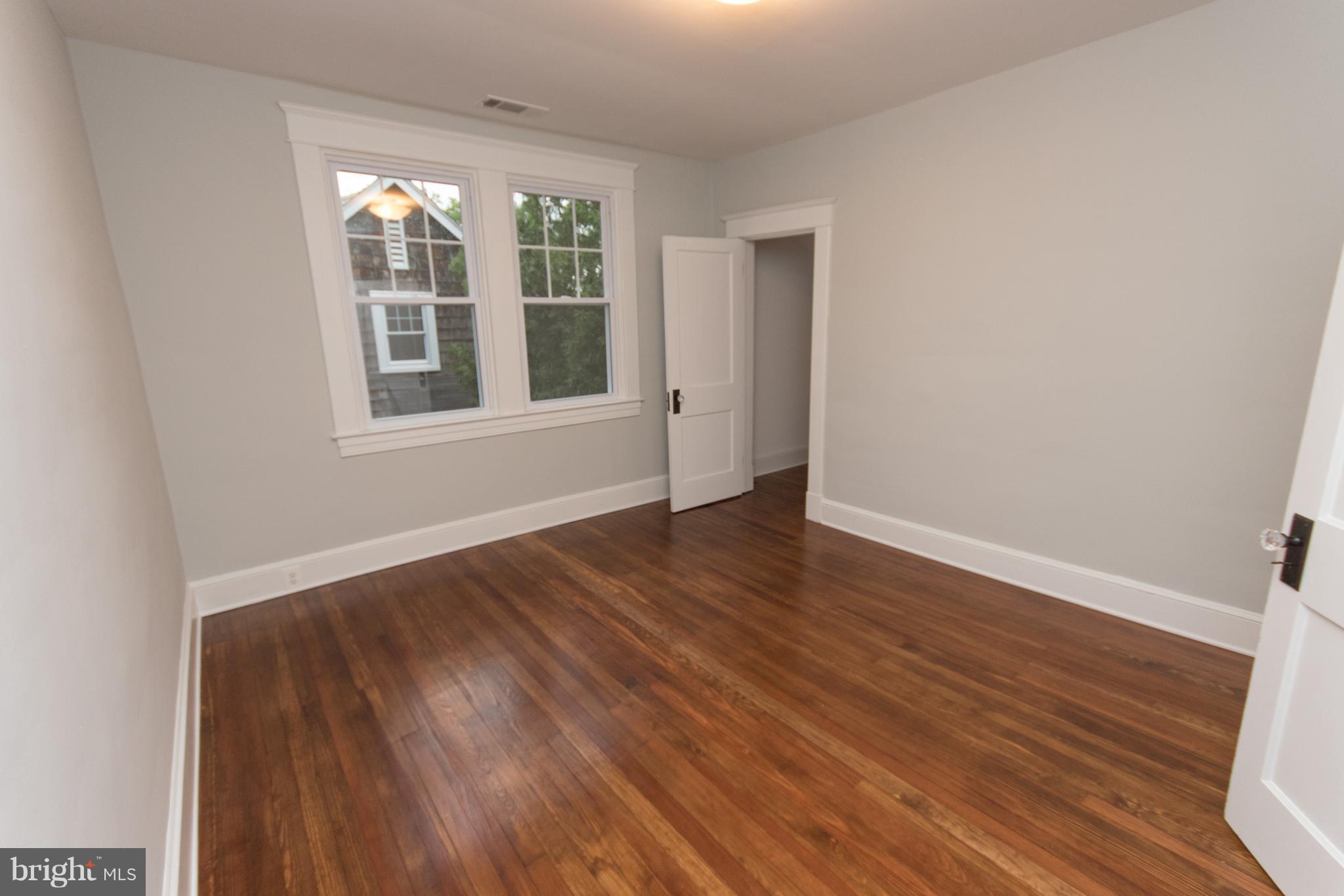 511 Dunkirk Road Baltimore, MD 21212 - Photo 21 of 27 wooden floor in an empty room with a window