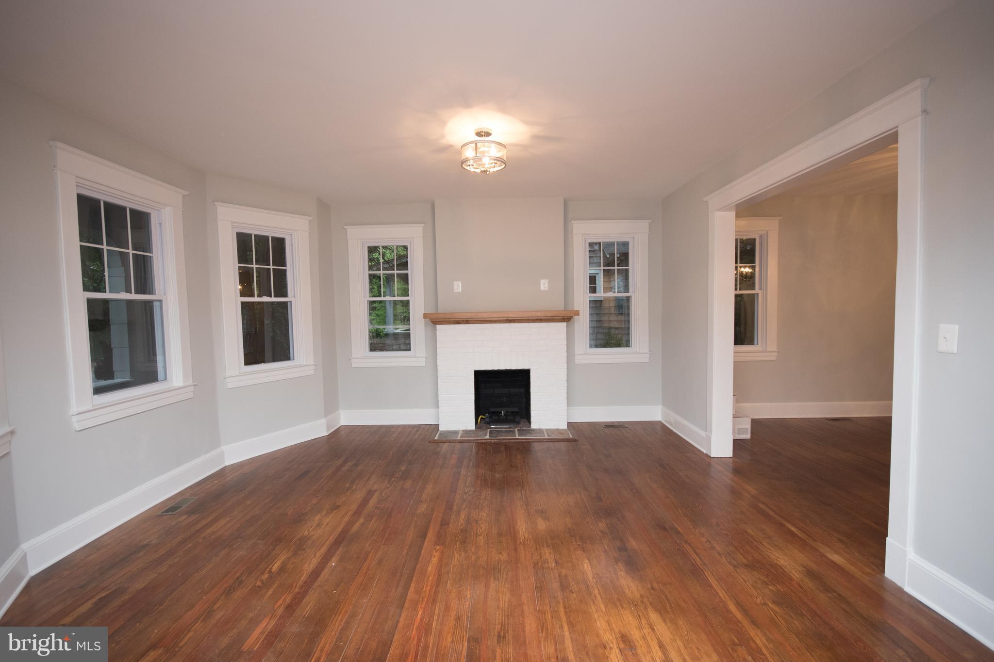 511 Dunkirk Road Baltimore, MD 21212 - Photo 4 of 27 a view of a livingroom with wooden floor fireplace and window