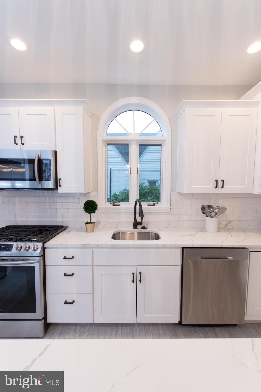 511 Dunkirk Road Baltimore, MD 21212 - Photo 6 of 27 a kitchen with stainless steel appliances a sink stove and cabinets