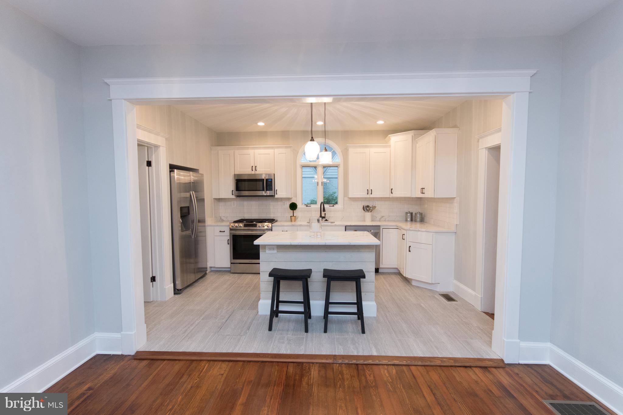 511 Dunkirk Road Baltimore, MD 21212 - Photo 8 of 27 a large white kitchen with a table and chairs