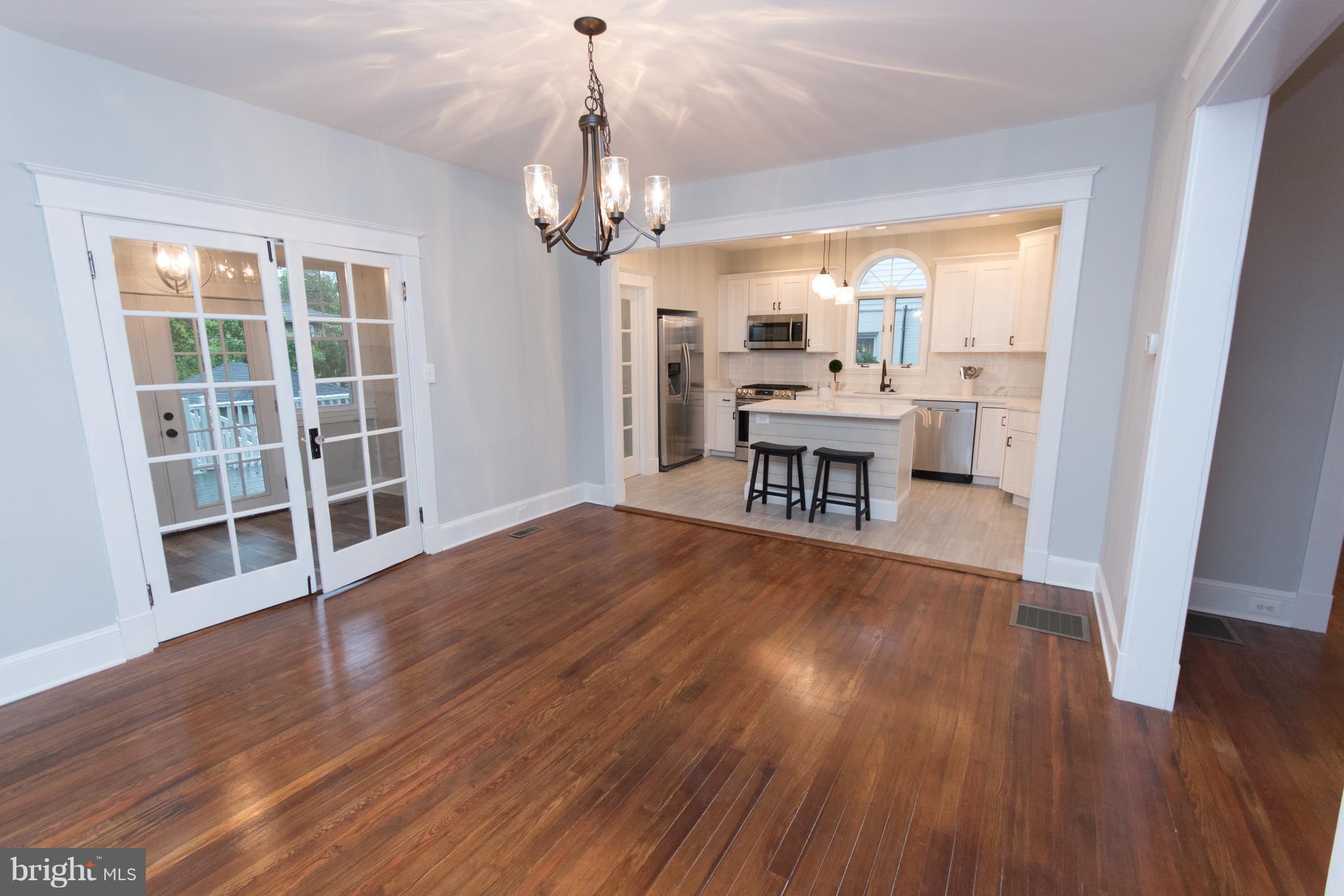 511 Dunkirk Road Baltimore, MD 21212 - Photo 9 of 27 a view of a livingroom with furniture wooden floor and chandelier