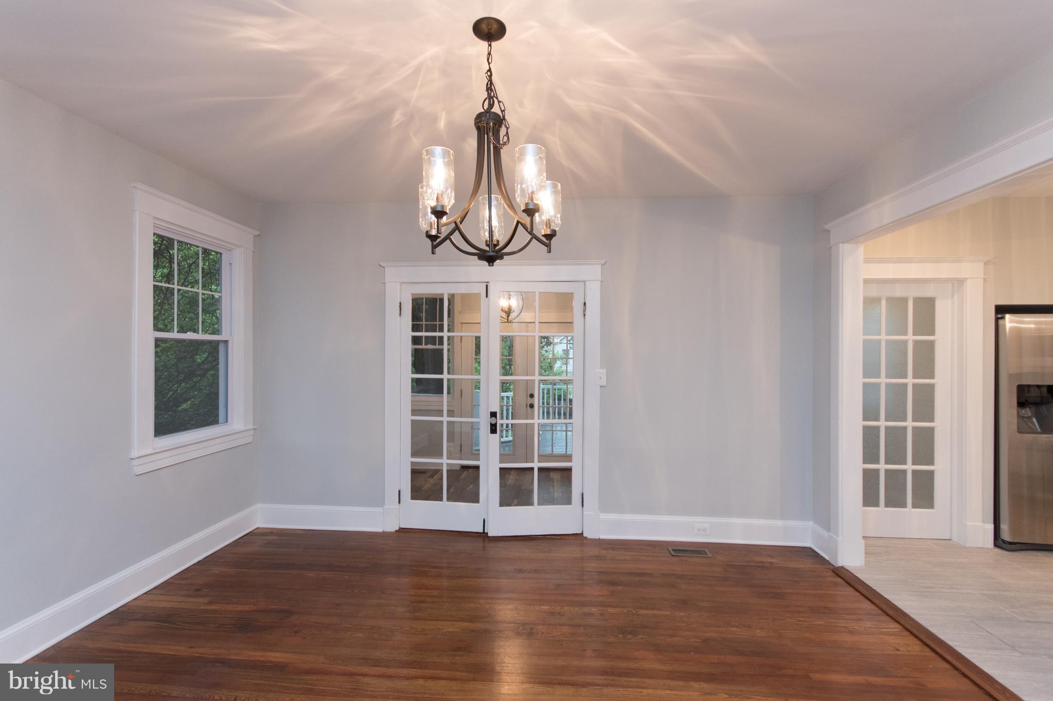 511 Dunkirk Road Baltimore, MD 21212 - Photo 10 of 27 a view of empty room with wooden floor and windows