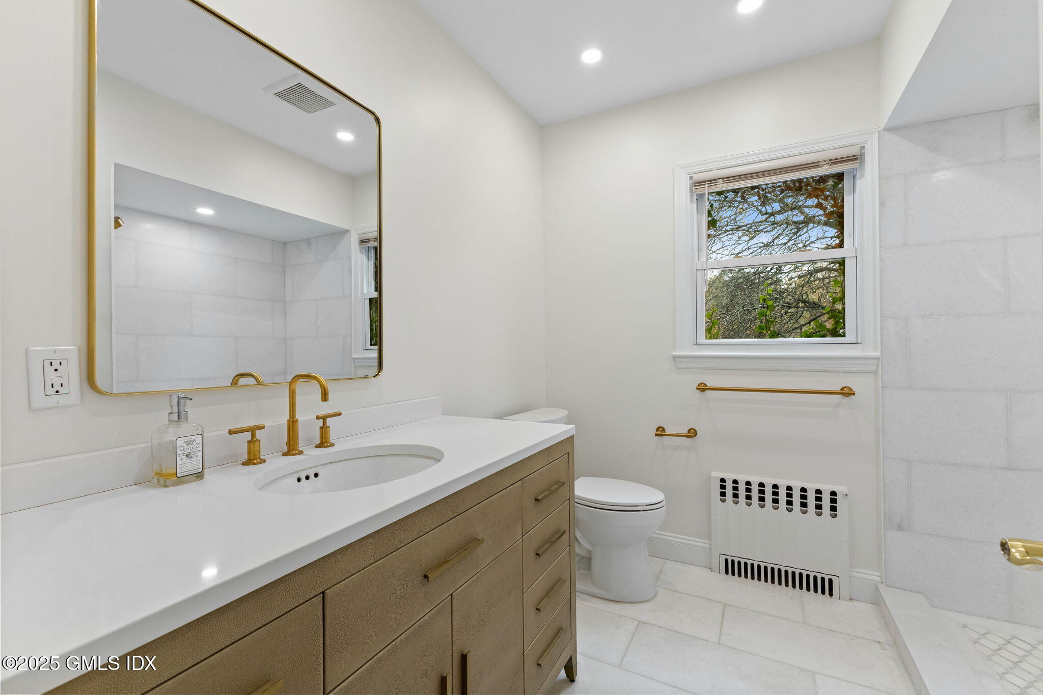 11 Gregory Road Cos Cob, CT 06807 - Photo 12 of 18 a bathroom with a sink a toilet and a mirror