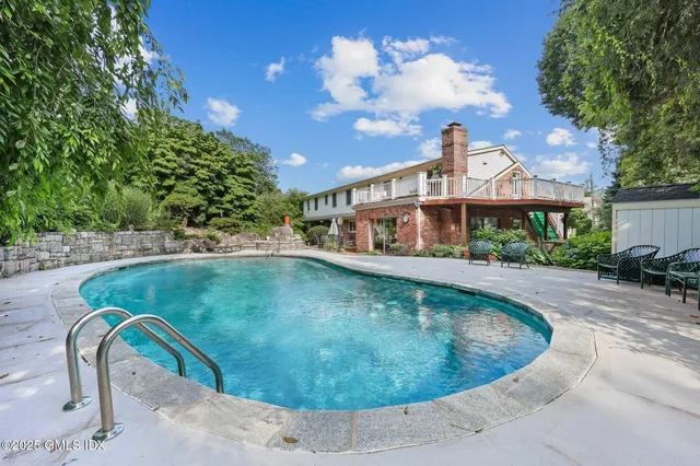 a view of a swimming pool with a yard