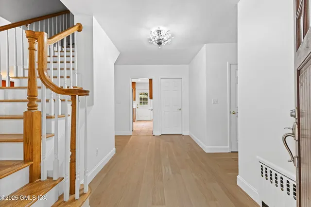 a view of an entryway with wooden floor