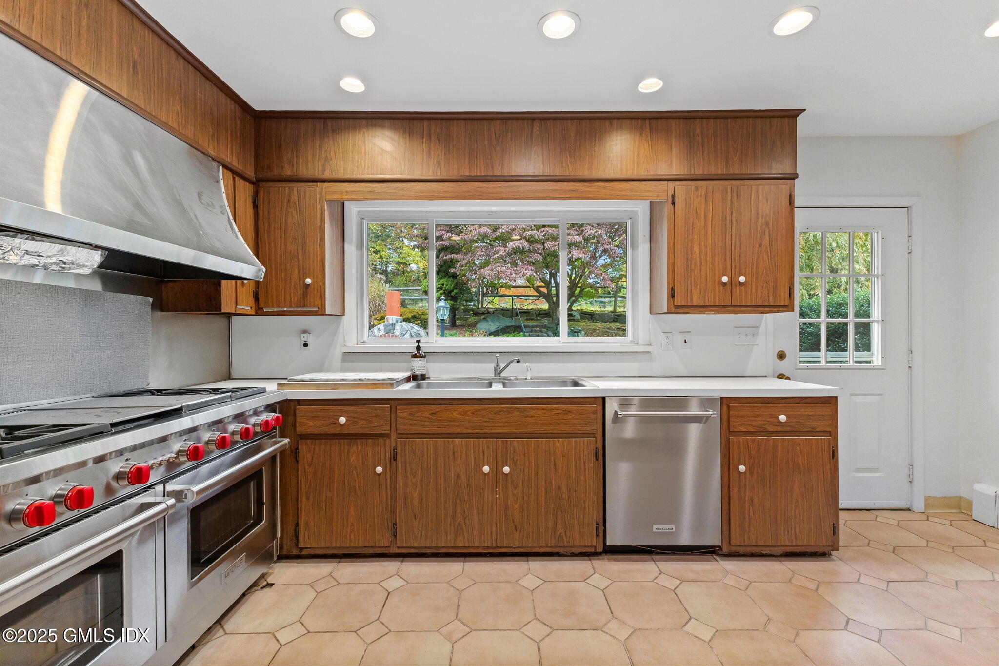 11 Gregory Road Cos Cob, CT 06807 - Photo 7 of 18 a large kitchen with stainless steel appliances granite countertop a stove a sink and a refrigerator