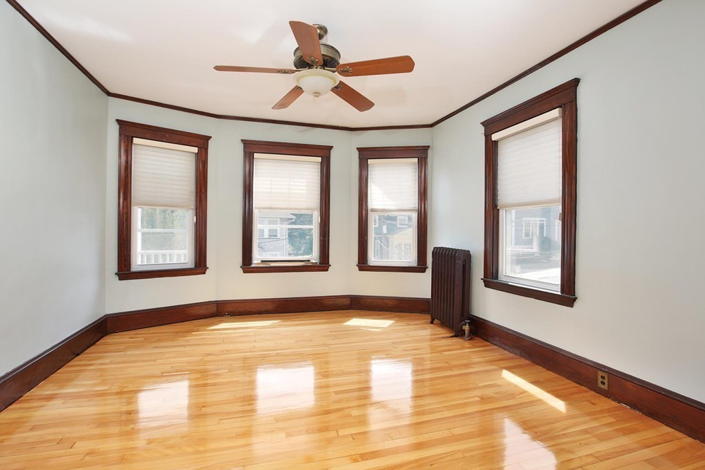 14-16 Presentation Road Boston, MA 02135 - Photo 8 of 12 a view of an empty room with a window and wooden floor