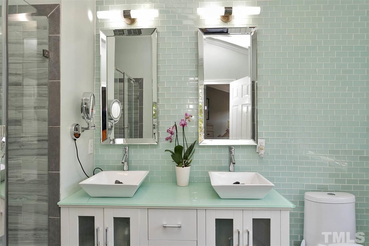7206 Doverton Court Raleigh, NC 27615 - Photo 14 of 23 a bathroom with a double vanity sink and a mirror