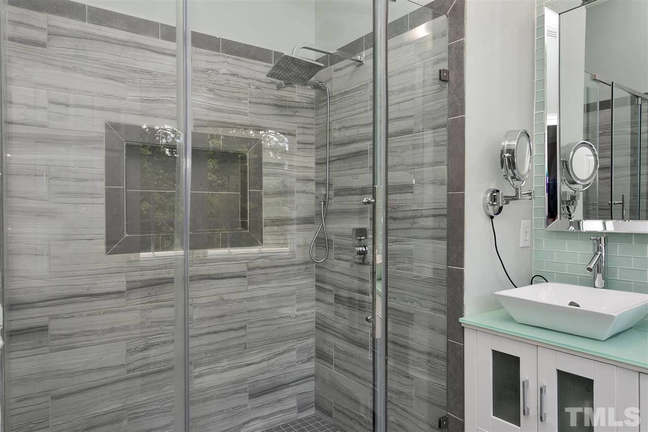7206 Doverton Court Raleigh, NC 27615 - Photo 15 of 23 a bathroom with a shower and a sink