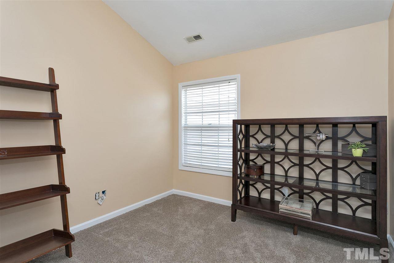 7206 Doverton Court Raleigh, NC 27615 - Photo 16 of 23 a view of a room with racks on the wall