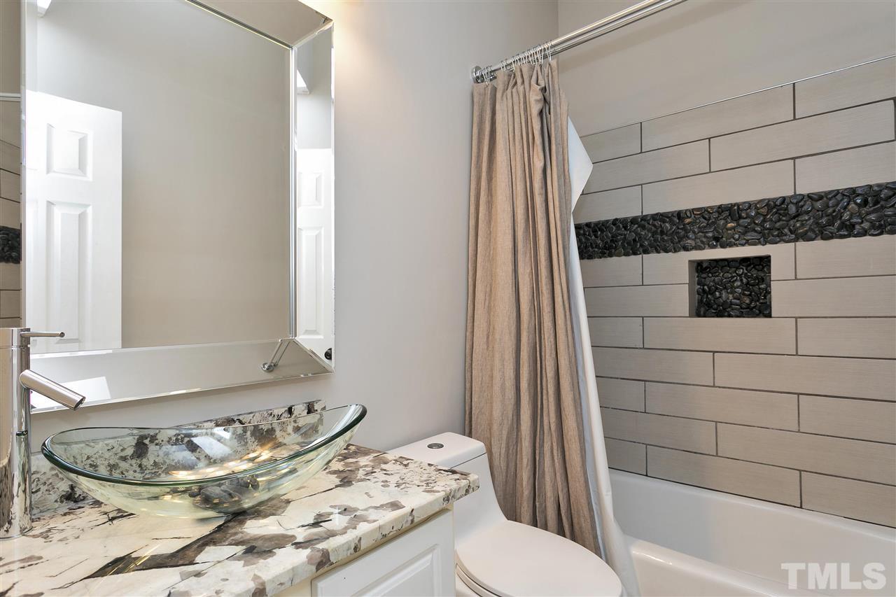 7206 Doverton Court Raleigh, NC 27615 - Photo 17 of 23 a bathroom with a sink toilet and shower
