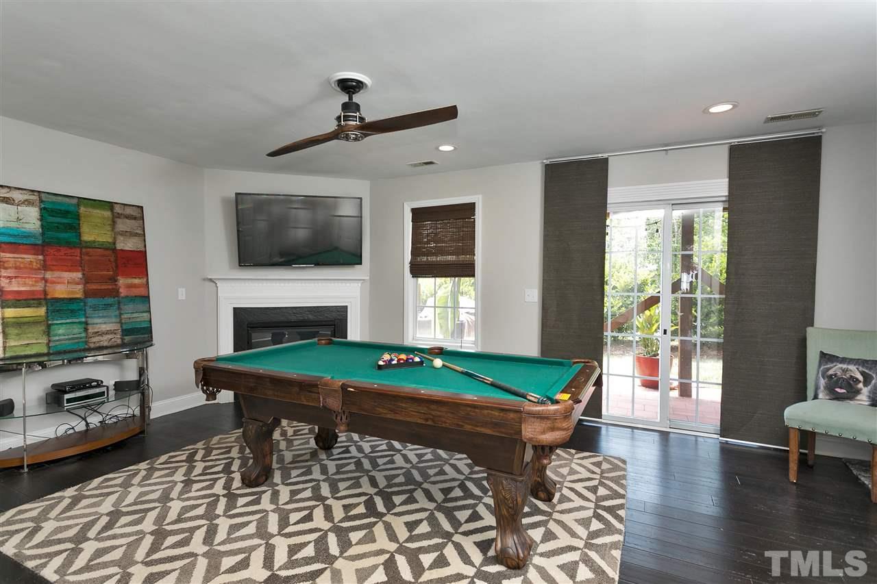 7206 Doverton Court Raleigh, NC 27615 - Photo 18 of 23 a room with furniture a flat screen tv and a fireplace