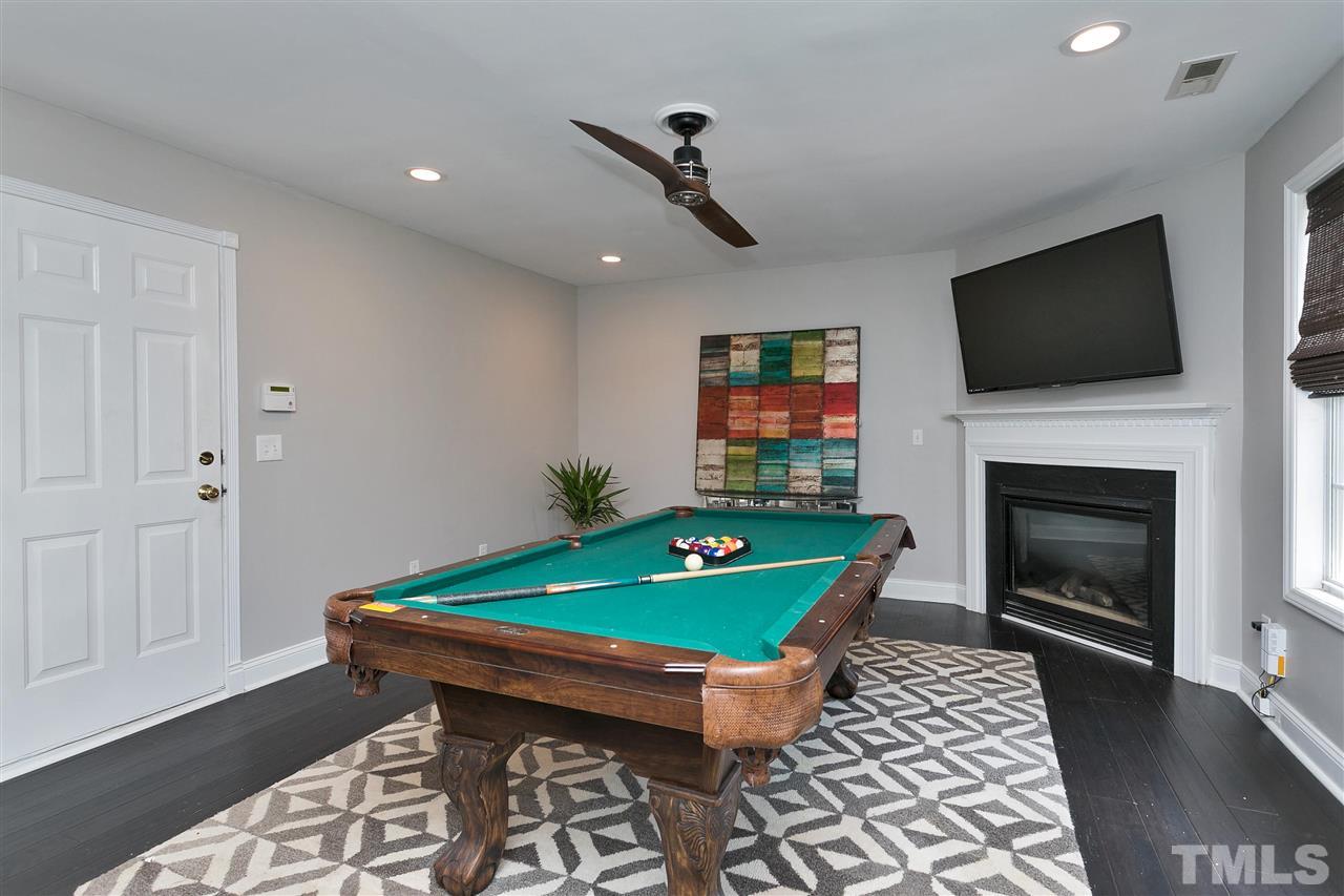 7206 Doverton Court Raleigh, NC 27615 - Photo 19 of 23 a room with furniture fireplace and flat screen tv