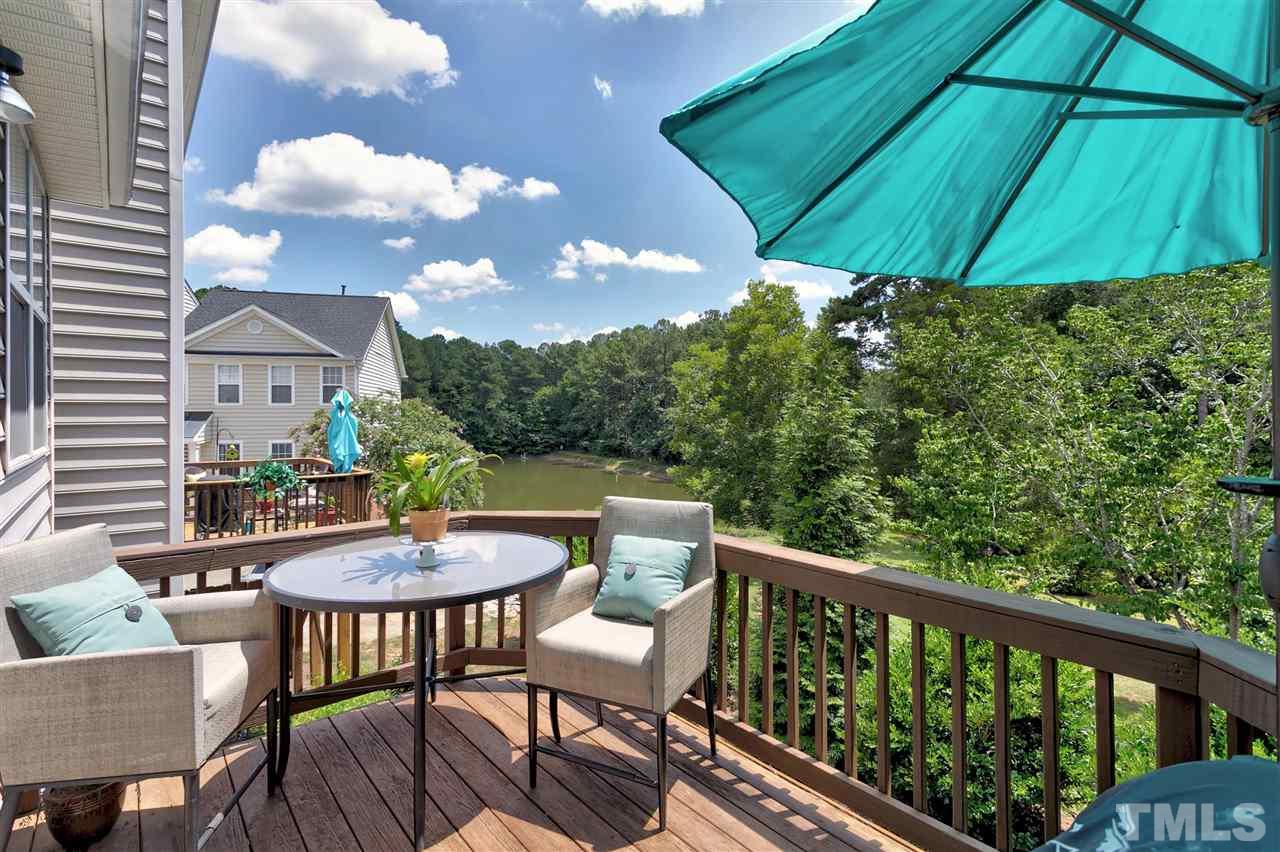 7206 Doverton Court Raleigh, NC 27615 - Photo 20 of 23 a patio with wooden floor a yard tables and chairs