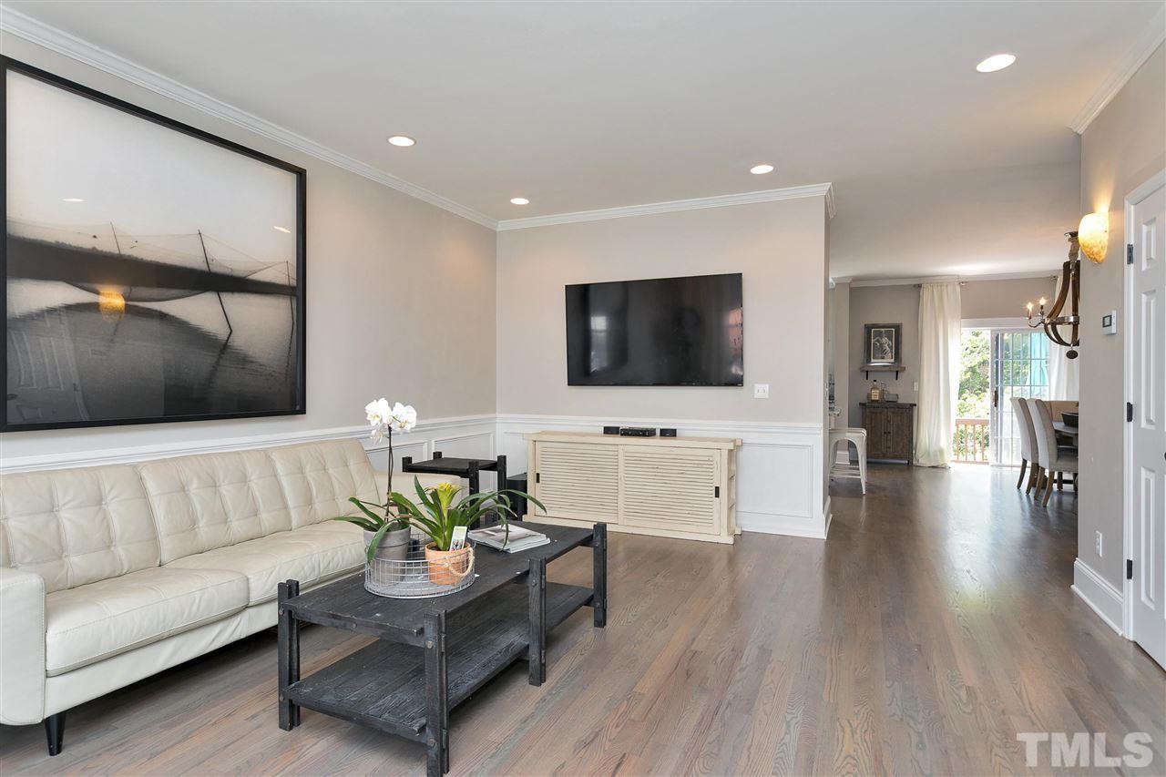 7206 Doverton Court Raleigh, NC 27615 - Photo 3 of 23 a living room with furniture and a flat screen tv
