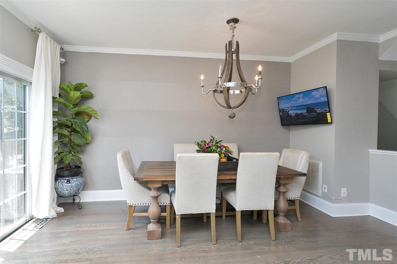 7206 Doverton Court Raleigh, NC 27615 - Photo 10 of 23 a view of a dining room with furniture and chandelier