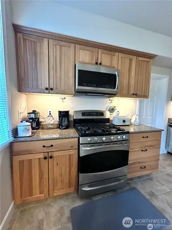 a kitchen with stainless steel appliances granite countertop a stove and a sink