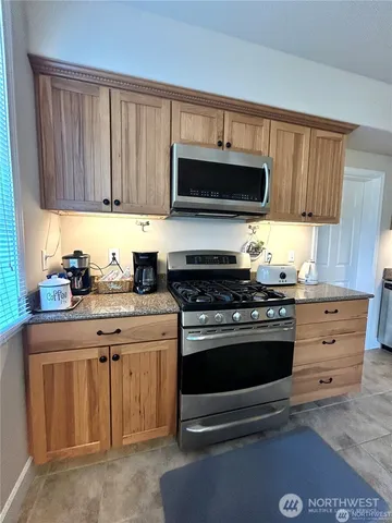 a kitchen with stainless steel appliances granite countertop a stove and a sink