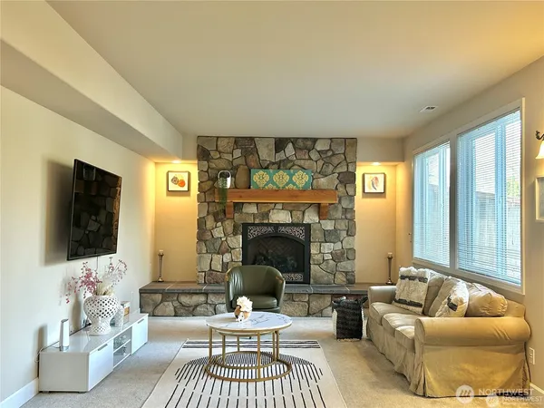 a living room with furniture a fireplace and a flat screen tv