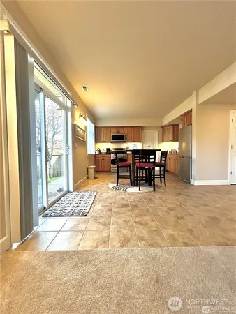 a view of living room filled with furniture and large window