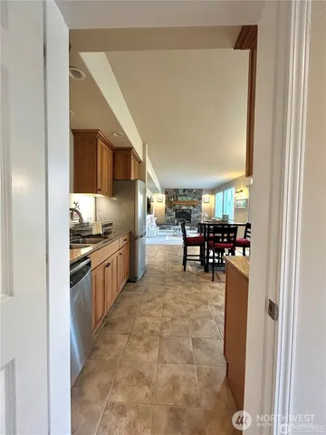 a kitchen with stainless steel appliances granite countertop a refrigerator and a stove