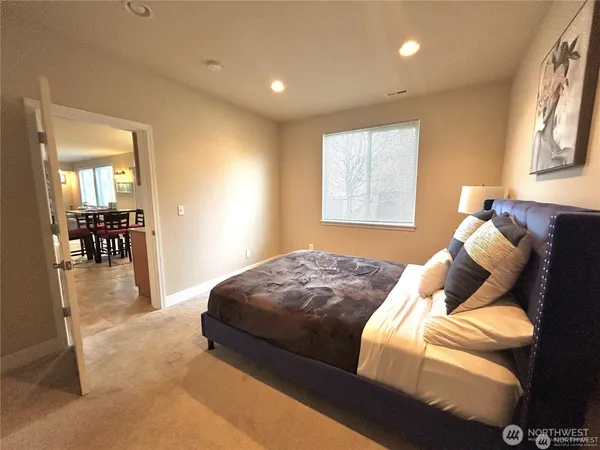 a bed sitting in a bedroom next to a window