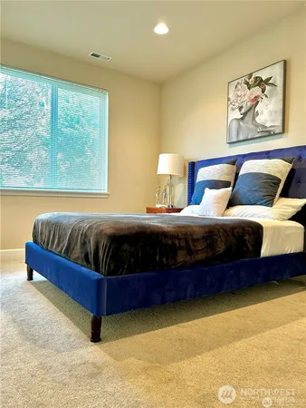 a bedroom with a bed and window