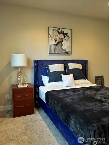 a bed room with a bed and a night stand