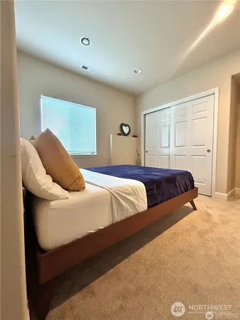 a bedroom with a bed and closet