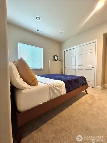 a bedroom with a bed and closet