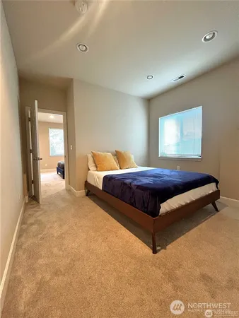 a spacious bedroom with a bed and window