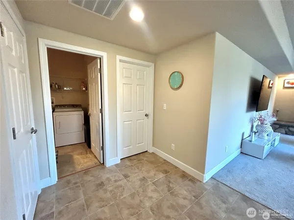 a view of a kitchen with granite countertop a sink and a refrigerator
